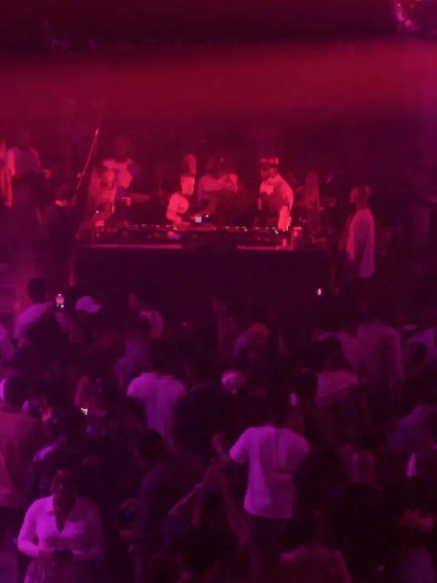 The crowd in crimson light